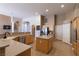 Bright kitchen with an island, stainless steel appliances, wood cabinets, and tile floors at 6493 Yellow Bells Ct, Las Vegas, NV 89131