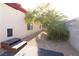 Property side yard with small staircase, desert landscaping, and mature trees at 6493 Yellow Bells Ct, Las Vegas, NV 89131