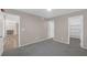 This bedroom features plush gray carpeting, and is adjacent to a walk-in closet and a living area with a fireplace at 701 Capri Dr # 6A, Boulder City, NV 89005
