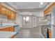 Open kitchen featuring wooden cabinets, updated appliances, and wood-look flooring at 701 Capri Dr # 6A, Boulder City, NV 89005