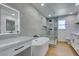 Modern bathroom featuring a large glass shower, tub, and vanity with lighting at 7133 Tropical Island Cir, Las Vegas, NV 89129