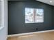 Neutral colored bedroom with wood floor, gray accent wall, and window at 7133 Tropical Island Cir, Las Vegas, NV 89129