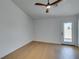 Bedroom with a ceiling fan, light wood floors and a view to the yard through the glass door at 7133 Tropical Island Cir, Las Vegas, NV 89129