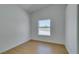 Bright, empty bedroom featuring light wood-look floors and a window at 7133 Tropical Island Cir, Las Vegas, NV 89129