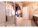 Bright bathroom featuring tiled floors, a glass enclosed shower, a soaking tub, and a double sink vanity at 815 Adagio St, Henderson, NV 89052