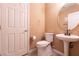 Cozy half bath with tile floors, toilet, and pedestal sink at 815 Adagio St, Henderson, NV 89052