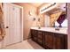 Bathroom featuring double sink vanity with granite countertop, and decorative mirrors at 815 Adagio St, Henderson, NV 89052