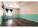 Large bedroom with wood floors, neutral walls, modern ceiling fan, and ample space for a desk at 815 Adagio St, Henderson, NV 89052