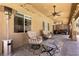 Inviting covered patio with ceiling fan, chairs, patio heater, and a grill at 815 Adagio St, Henderson, NV 89052