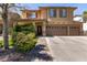 Well-maintained two-story home with a three-car garage, desert landscaping, and a cozy porch at 815 Adagio St, Henderson, NV 89052