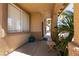 Covered front porch with seating area, offering a welcoming space with desert landscaping views at 815 Adagio St, Henderson, NV 89052