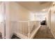 Upstairs hallway with carpet flooring, white railing, and an armchair at 815 Adagio St, Henderson, NV 89052