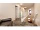 Upstairs hallway with carpet flooring, white railing, and an armchair at 815 Adagio St, Henderson, NV 89052