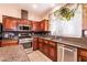 Well-lit kitchen features stainless appliances, tile flooring, and granite countertops at 815 Adagio St, Henderson, NV 89052