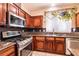 Well-appointed kitchen with stainless appliances, dark cabinetry, and tile floors at 815 Adagio St, Henderson, NV 89052