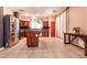 Well-lit kitchen features stainless appliances, dark cabinetry, and tile floors at 815 Adagio St, Henderson, NV 89052