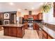 Modern kitchen with stainless appliances, dark cabinetry, and center island at 815 Adagio St, Henderson, NV 89052