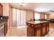 Open concept kitchen with a breakfast bar leading into a living room space at 815 Adagio St, Henderson, NV 89052