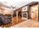 Spacious living room featuring a fireplace, mounted television, ceiling fan, and comfortable seating at 815 Adagio St, Henderson, NV 89052