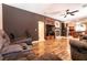 Open-concept living room featuring a fireplace, ceiling fan, and hardwood floors at 815 Adagio St, Henderson, NV 89052