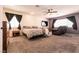 Spacious main bedroom features a ceiling fan, sitting area, and carpeting at 815 Adagio St, Henderson, NV 89052