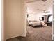 Carpeted main bedroom with a ceiling fan and an adjacent living space at 815 Adagio St, Henderson, NV 89052