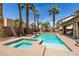 Beautiful pool and spa surrounded by palm trees with a covered patio and BBQ at 815 Adagio St, Henderson, NV 89052