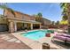 Beautiful pool with spa, covered patio, outdoor seating, and desert landscaping at 815 Adagio St, Henderson, NV 89052