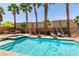 Sparkling pool with integrated spa, surrounded by palm trees and lounge area at 815 Adagio St, Henderson, NV 89052