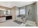 Luxurious bathroom featuring a separate shower and tub, dual sinks, and modern fixtures at 8531 W Oquendo Rd, Las Vegas, NV 89113