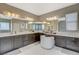 Double sink bathroom with large mirrors, dark cabinets, and ample counter space at 8531 W Oquendo Rd, Las Vegas, NV 89113
