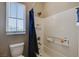Bright bathroom with a shower-tub combination and a window for natural light at 8531 W Oquendo Rd, Las Vegas, NV 89113