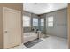 Modern bathroom featuring a soaking tub, glass-enclosed shower, and stylish gray tiling at 8531 W Oquendo Rd, Las Vegas, NV 89113