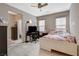 Cozy bedroom with wood flooring, a ceiling fan, and natural light, featuring a comfortable bed and dresser at 8531 W Oquendo Rd, Las Vegas, NV 89113