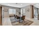 Cozy dining area with stylish furniture, decor, and views of the backyard through a sliding glass door at 8531 W Oquendo Rd, Las Vegas, NV 89113
