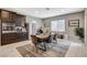 Bright dining room with a wooden table, seating for six, and views of the stainless steel appliances in the kitchen at 8531 W Oquendo Rd, Las Vegas, NV 89113