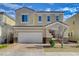 Charming two-story home featuring a brick driveway, a two-car garage, and a neatly landscaped front yard at 8531 W Oquendo Rd, Las Vegas, NV 89113