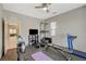Bright, spacious gym with black mats, neutral walls, a ceiling fan, and an outside view through a window at 8531 W Oquendo Rd, Las Vegas, NV 89113