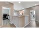 Open hallway with views to office and laundry room; grey tones and wood flooring at 8531 W Oquendo Rd, Las Vegas, NV 89113