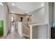 Upstairs hallway featuring wood-look flooring and stylish white banister leading to stairs at 8531 W Oquendo Rd, Las Vegas, NV 89113