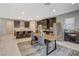 Spacious kitchen with stainless steel appliances, dark wood cabinets, and an island with bar seating at 8531 W Oquendo Rd, Las Vegas, NV 89113