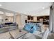 Comfortable living room with stylish sofas, neutral decor, and an open layout that connects to the kitchen at 8531 W Oquendo Rd, Las Vegas, NV 89113