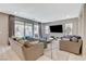 Bright living room features large sliding glass doors, neutral decor, and plush seating at 8531 W Oquendo Rd, Las Vegas, NV 89113