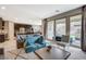 Open floor plan blending the kitchen and living room with sliding glass doors to the backyard at 8531 W Oquendo Rd, Las Vegas, NV 89113
