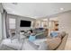 Inviting living room featuring a comfortable sofa, neutral walls, and access to natural light through sliding glass doors at 8531 W Oquendo Rd, Las Vegas, NV 89113
