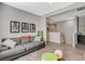 Cozy living room with a comfortable gray couch, wood floors, and an open floor plan at 8531 W Oquendo Rd, Las Vegas, NV 89113