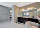 Bright main bathroom with a double vanity and a large mirror at 8531 W Oquendo Rd, Las Vegas, NV 89113