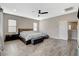 Spacious main bedroom with wood-look floors, a ceiling fan, and two windows at 8531 W Oquendo Rd, Las Vegas, NV 89113