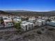 Aerial view of a modern home in a desert community with city views and well-maintained landscaping at 865 Auroras Edge Ct, Henderson, NV 89012