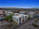 Aerial view of a modern home in a desert community with city views and drought-tolerant landscaping at 865 Auroras Edge Ct, Henderson, NV 89012